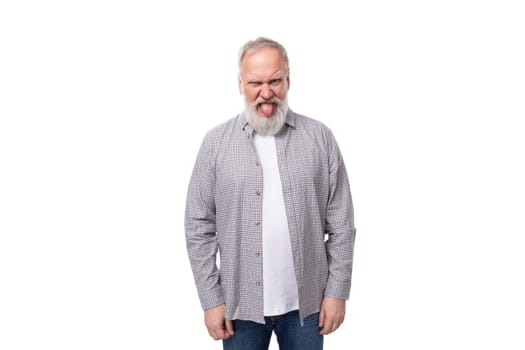 handsome gray-haired elderly man with a beard in a checkered shirt on a white background with copy space.