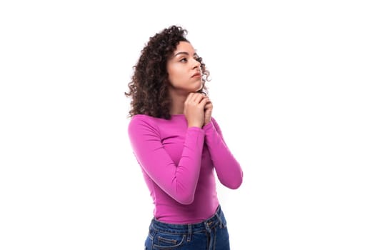 young leader woman with curly black hair wearing a lilac sweater brainstorming to generate ideas.