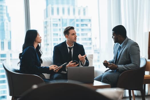 Young smart businesswoman showing data analysis to diverse investor by using tablet. Multicultural business group discussing and investing in start up project. Modern office. Meeting. Ornamented.