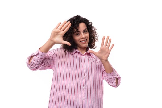 confident young office secretary woman dressed in a striped pink shirt gesturing with her hands.