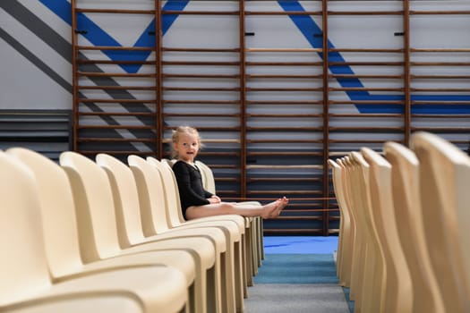 Gymnast girl sitting in the auditorium
