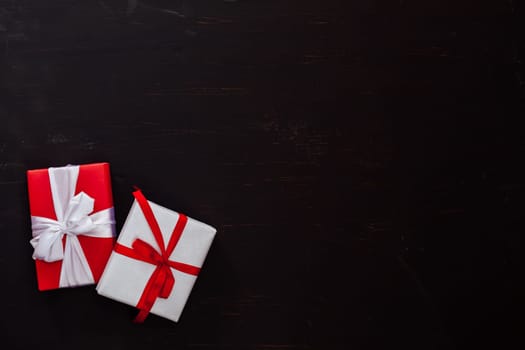 two Christmas birthday gifts on a black background