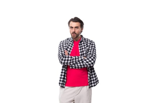 young well-groomed brunette caucasian man with a stylish hairstyle and beard on a white background.