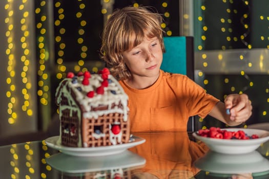 Immerse in festive delight as a boy crafts boy crafting an unconventional gingerbread house, infusing Christmas with unique creativity and festive cheer. A sweet scene of seasonal bonding and culinary fun.