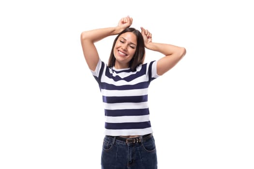 young lucky happy brunette woman with straight hair dressed in a striped t-shirt.