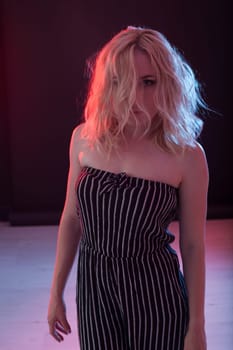 Portrait of a beautiful blonde woman in a striped suit