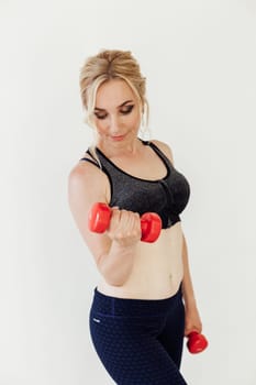 Blonde woman sports fitness with dumbbells