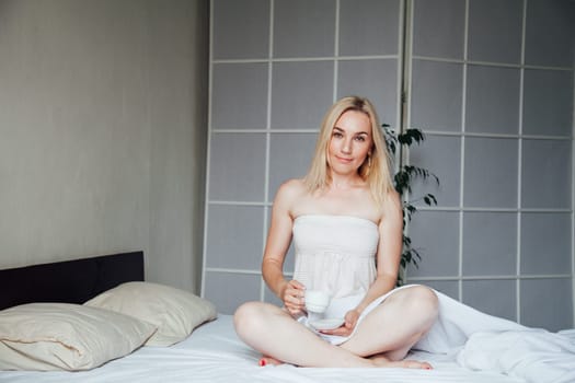 Woman blonde breakfast in the morning in the sleep on the bed