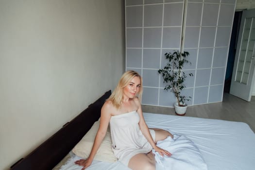 woman blonde woke up in the morning in the sleep on the bed