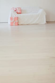 white sofa with gifts in the interior of the room