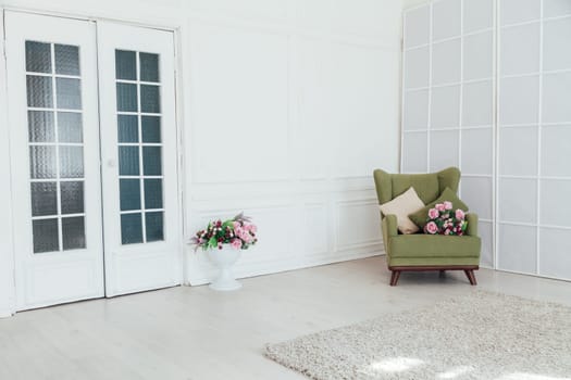 green chair in the interior of an empty white room