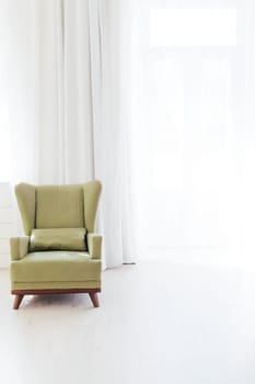 green chair in the interior of an empty white room