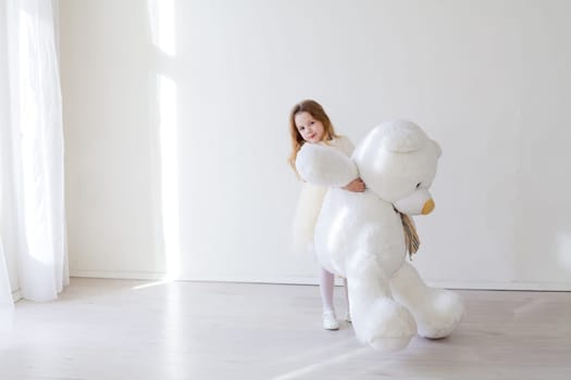 Beautiful little girl with toy big bear