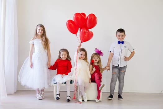 beautiful little kids with red balloons