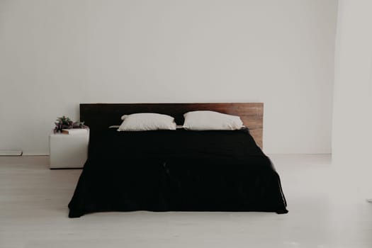 Interior white spal'nti bed with black linen