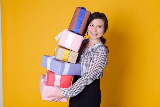 woman holds holiday gifts for her birthday