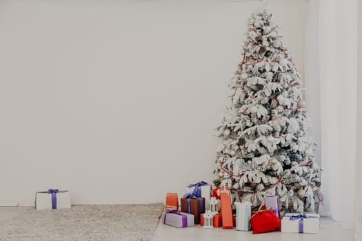 apartment decor for the new year with a Christmas tree and gifts