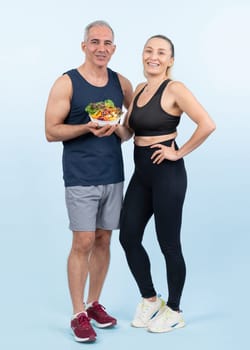 Happy smile senior man and woman portrait holding bowl of vegan fruit and vegetable on isolated background. Healthy senior couple with healthy vegetarian nutrition and body care lifestyle. Clout