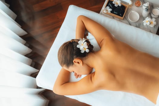 Panorama top view woman customer enjoying relaxing anti-stress spa massage and pampering with beauty skin recreation leisure in day light ambient salon spa at luxury resort or hotel. Quiescent