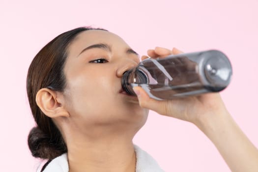 Athletic and sporty asian woman resting and drink water after intensive cardio workout training. Healthy exercising and fit body care lifestyle pursuit in studio shot isolated background. Vigorous