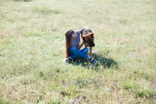 Woman trains trained sheepdog in field