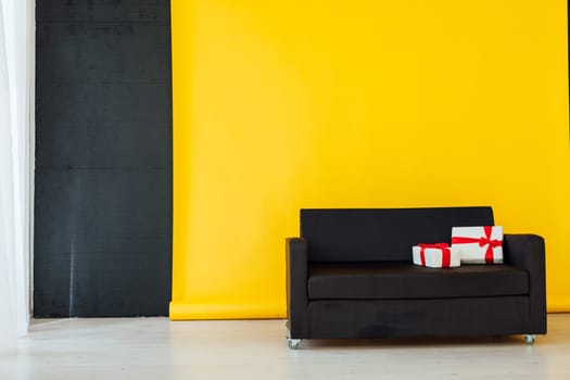 black sofa with gifts in the interer of the house