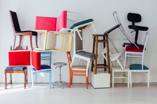 lots of different chairs in the interior of the white room moving