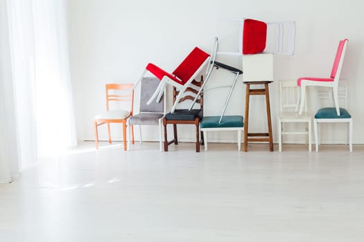 lots of different chairs in the interior of the white room moving