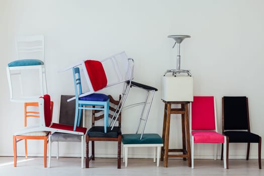 lots of different chairs in the interior of the white room moving