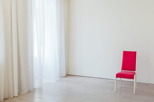 red chair in the interior of an empty white office