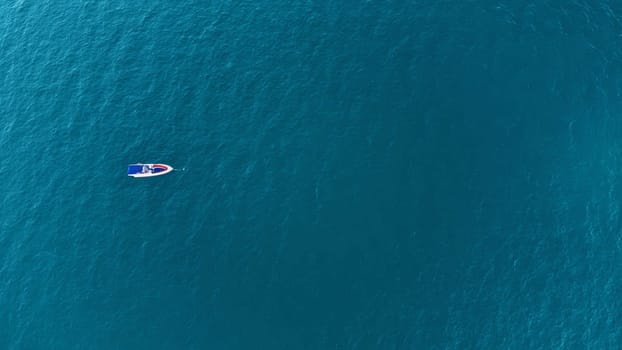 Aerial drone top down photo of speed boat anchored.