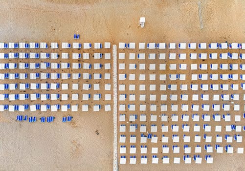 Top view on Turkey Resort Beach. Umbrellas, sand and chaise lounge