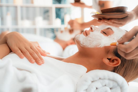 Serene ambiance of spa salon, couple indulges in rejuvenating with luxurious face cream massage with modern daylight. Facial skin treatment and beauty care concept. Quiescent