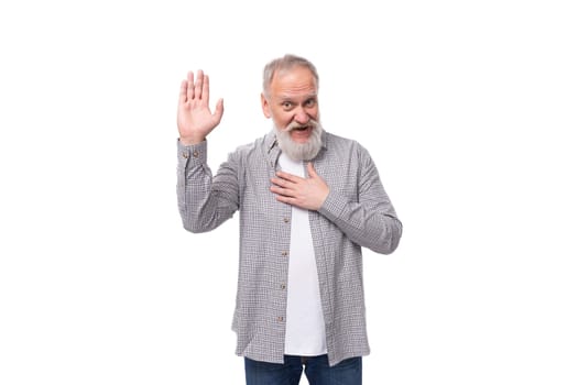 handsome funny gray-haired elderly man with a beard and mustache in a plaid shirt on a white background with copy space.