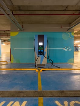 DC charging station to charge electric vehicles in the parking garage of the shopping mall