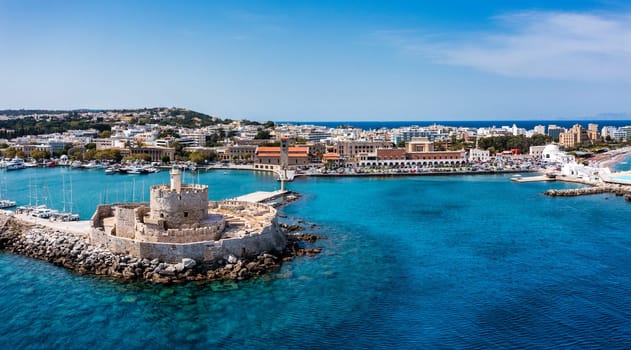 Mandraki port with deers statue, where The Colossus was standing and fort of St. Nicholas. Rhodes, Greece. Hirschkuh statue in the place of the Colossus of Rhodes, Rhodes, Greece
