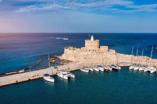 Mandraki port with deers statue, where The Colossus was standing and fort of St. Nicholas. Rhodes, Greece. Hirschkuh statue in the place of the Colossus of Rhodes, Rhodes, Greece