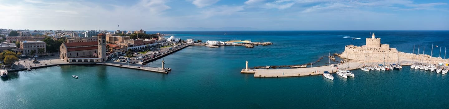 Mandraki port with deers statue, where The Colossus was standing and fort of St. Nicholas. Rhodes, Greece. Hirschkuh statue in the place of the Colossus of Rhodes, Rhodes, Greece