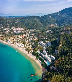 Agios Gordios exotic beach in Corfu island,Greece. Agios Gordios beach, Corfu island, Greece. Panoramic view of the Agios Gordios beach, sandy seashore with beach umbrellas and deck chairs.