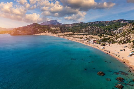 Tsampika beach with golden sand view from above, Rhodes, Greece. Aerial birds eye view of famous beach of Tsampika, Rhodes island, Dodecanese, Greece