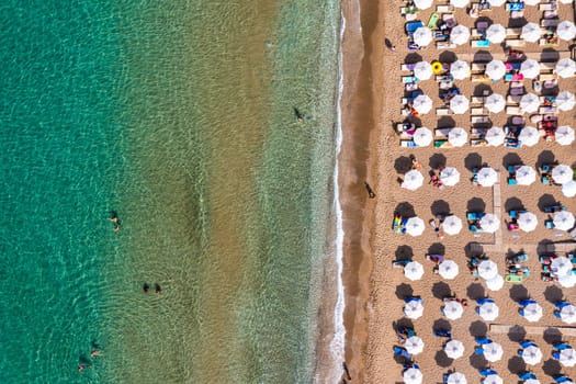 Tsampika beach with golden sand view from above, Rhodes, Greece. Aerial birds eye view of famous beach of Tsampika, Rhodes island, Dodecanese, Greece