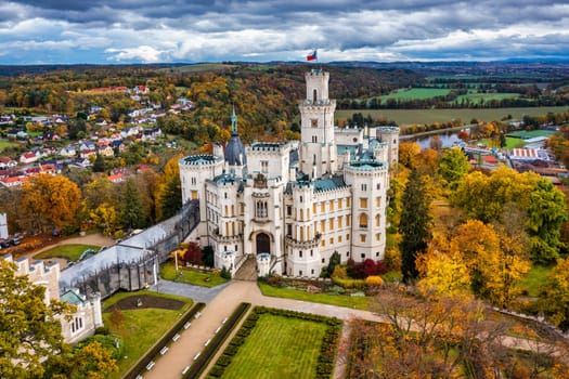 Castle Hluboka nad Vltavou is one of the most beautiful castles in Czech Republic. Castle Hluboka nad Vltavou in autumn with red foliage, Czechia. Colorful autumn view of Hluboka nad Vltavou castle.