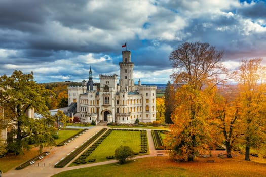 Castle Hluboka nad Vltavou is one of the most beautiful castles in Czech Republic. Castle Hluboka nad Vltavou in autumn with red foliage, Czechia. Colorful autumn view of Hluboka nad Vltavou castle.