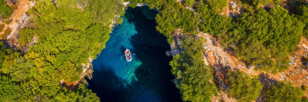 Melissani lake on Kefalonia island, Greece. Melissani Cave (Melissani Lake) near Sami village in Kefalonia island, Greece. Tourist boat on the lake in Melissani Cave, Kefalonia Island, Greece