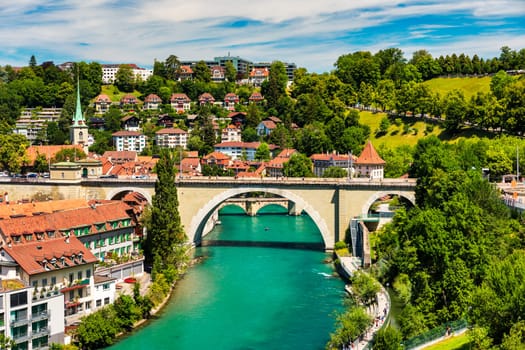 View of the Bern old city center and Nydeggbrucke bridge over river Aare, Bern, Switzerland. Bern old town with the Aare river flowing around the town on a sunny day, Bern, Switzerland.