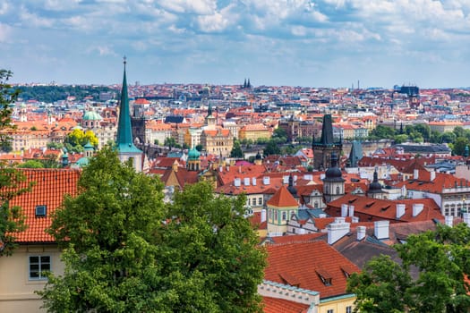 Old town of Prague. Czech Republic over river Vltava with Charles Bridge on skyline. Prague panorama landscape view with red roofs.  Prague view from Petrin Hill, Prague, Czechia.