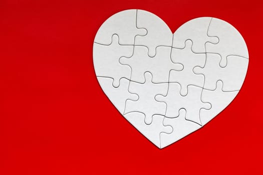 Heart object made of puzzle pieces. Make complete heart. Jigsaw puzzle pieces in form of heart. Happy Valentines Day, greeting card template. Heart jigsaw puzzle.