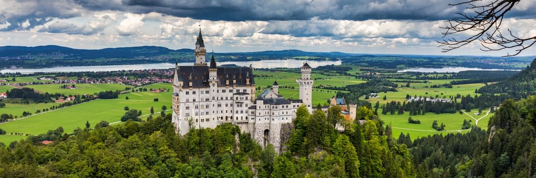 Famous Neuschwanstein Castle with scenic mountain landscape near Fussen, Bavaria, Germany. Neuschwanstein Castle in Hohenschwangau, Germany. 