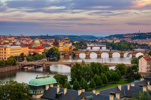 Scenic view of the Old Town pier architecture and Charles Bridge over Vltava river in Prague, Czech Republic. Prague iconic Charles Bridge (Karluv Most) and Old Town Bridge Tower at sunset, Czechia.