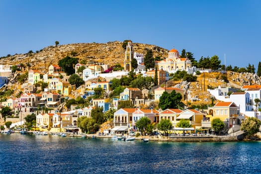 View of the beautiful greek island of Symi (Simi) with colourful houses and small boats. Greece, Symi island, view of the town of Symi (near Rhodes), Dodecanese.